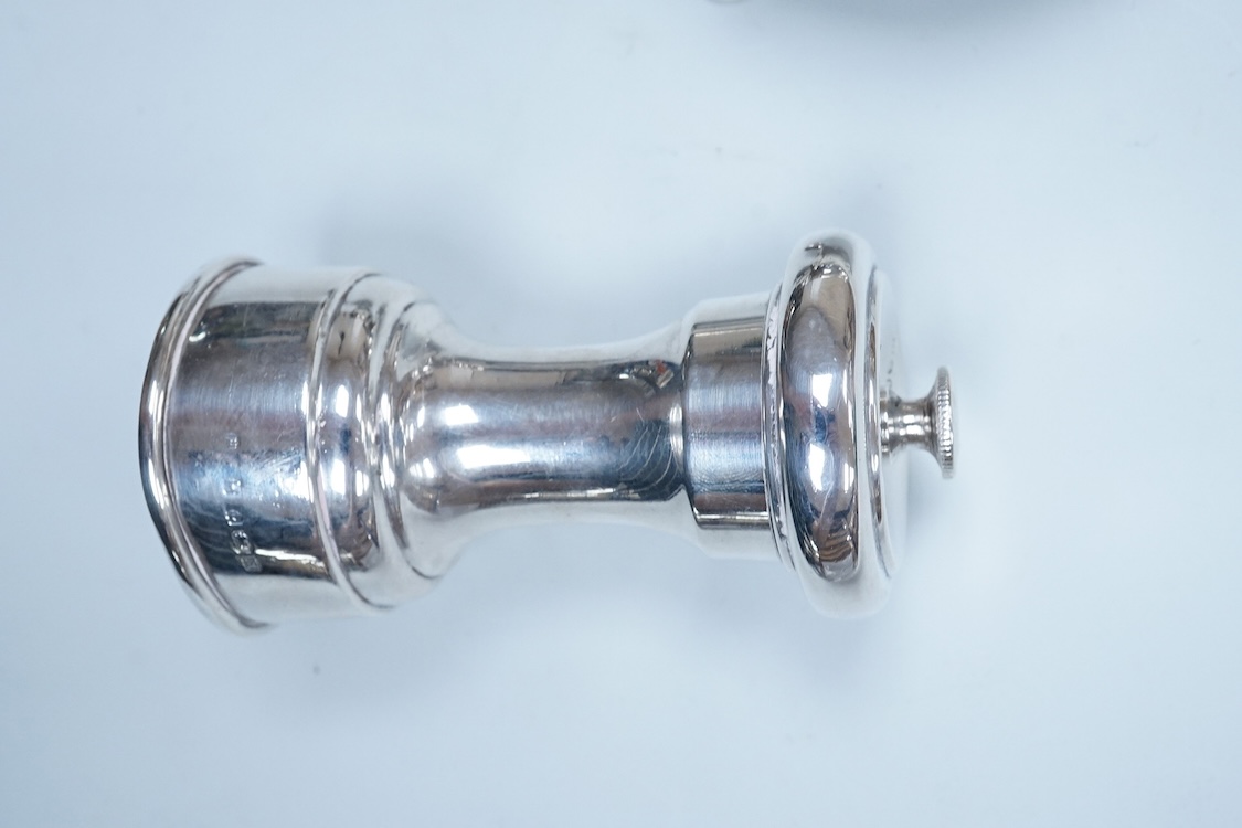 Two modern silver mounted pepper mills, 10.5cm, one other silver pepper mill by Hukin & Heath, Birmingham, 1926 and a pair of George III silver bun shaped salts, David Hennell I, London, 1750, with blue glass liners.